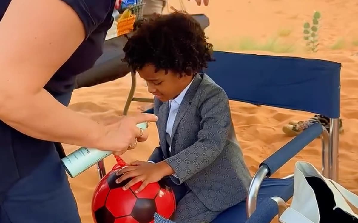 On-set hair and grooming support for young talent on a UAE desert production with camera crane in the background.