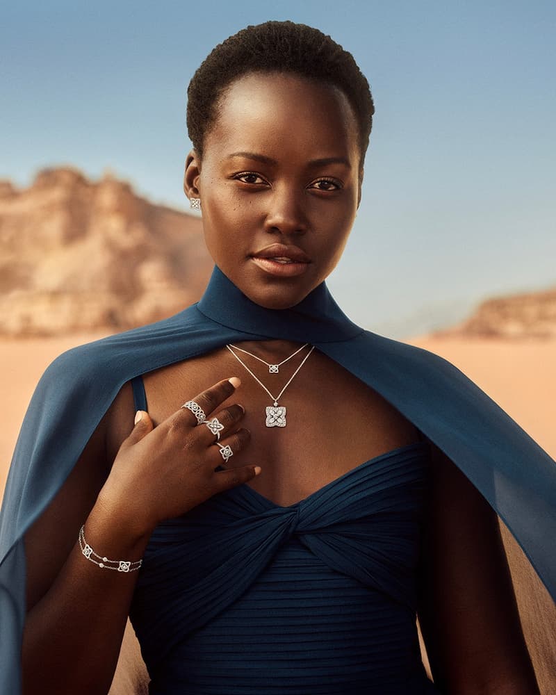 Jewellery talent in a blue dress wearing diamond rings, necklace, bracelet, and earrings against a Wadi Rum desert backdrop.