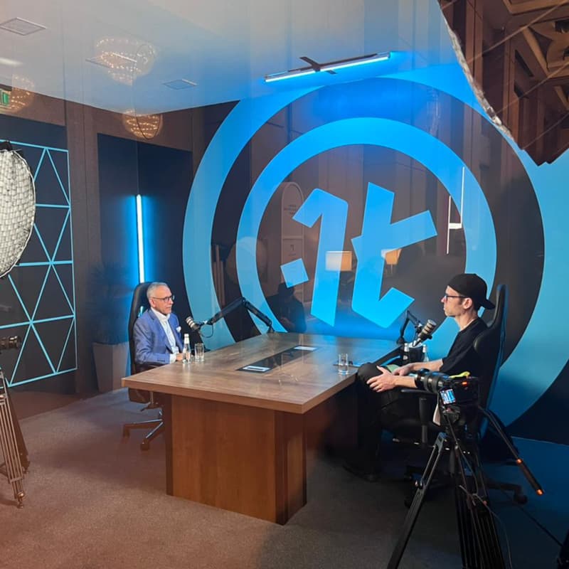 Podcast interview setup in Riyadh with microphones, cameras, lighting, two speakers, and studio production equipment.