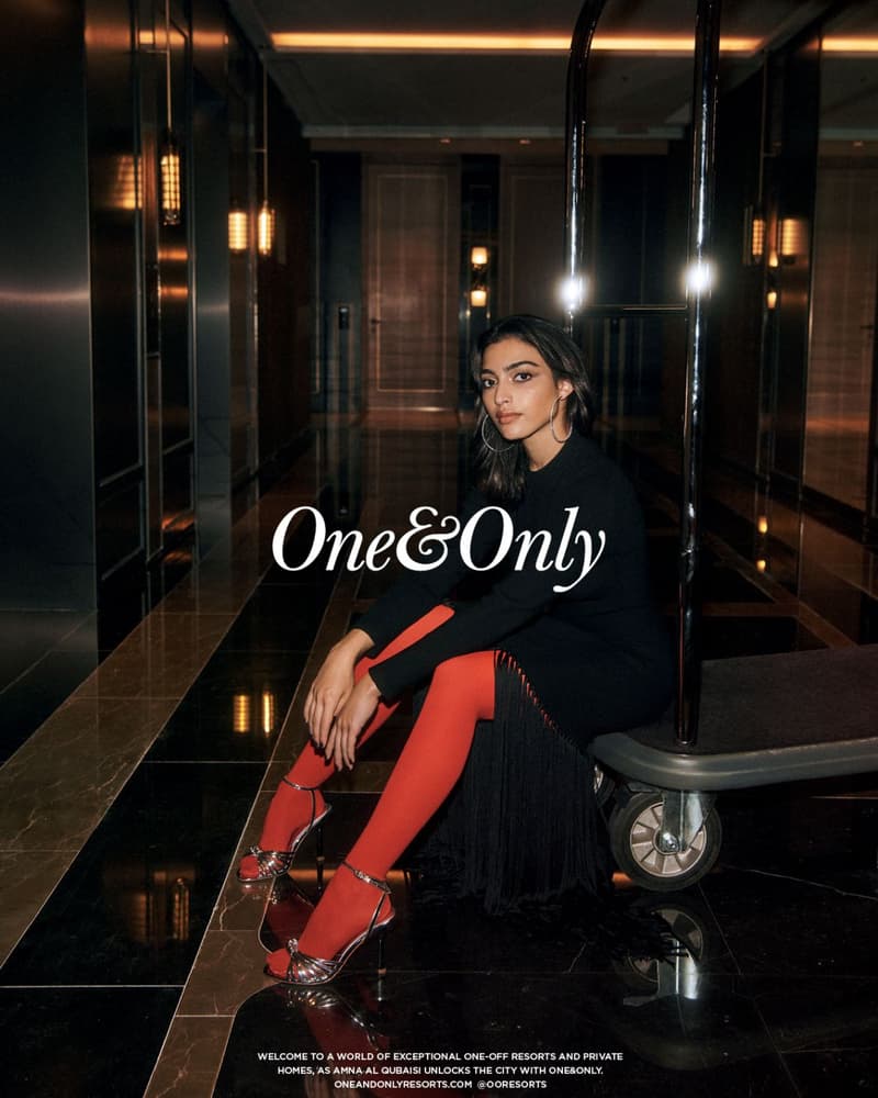Luxury hotel campaign image in Dubai with female talent seated on a luggage trolley in a dark interior with visible One&Only wordmark.