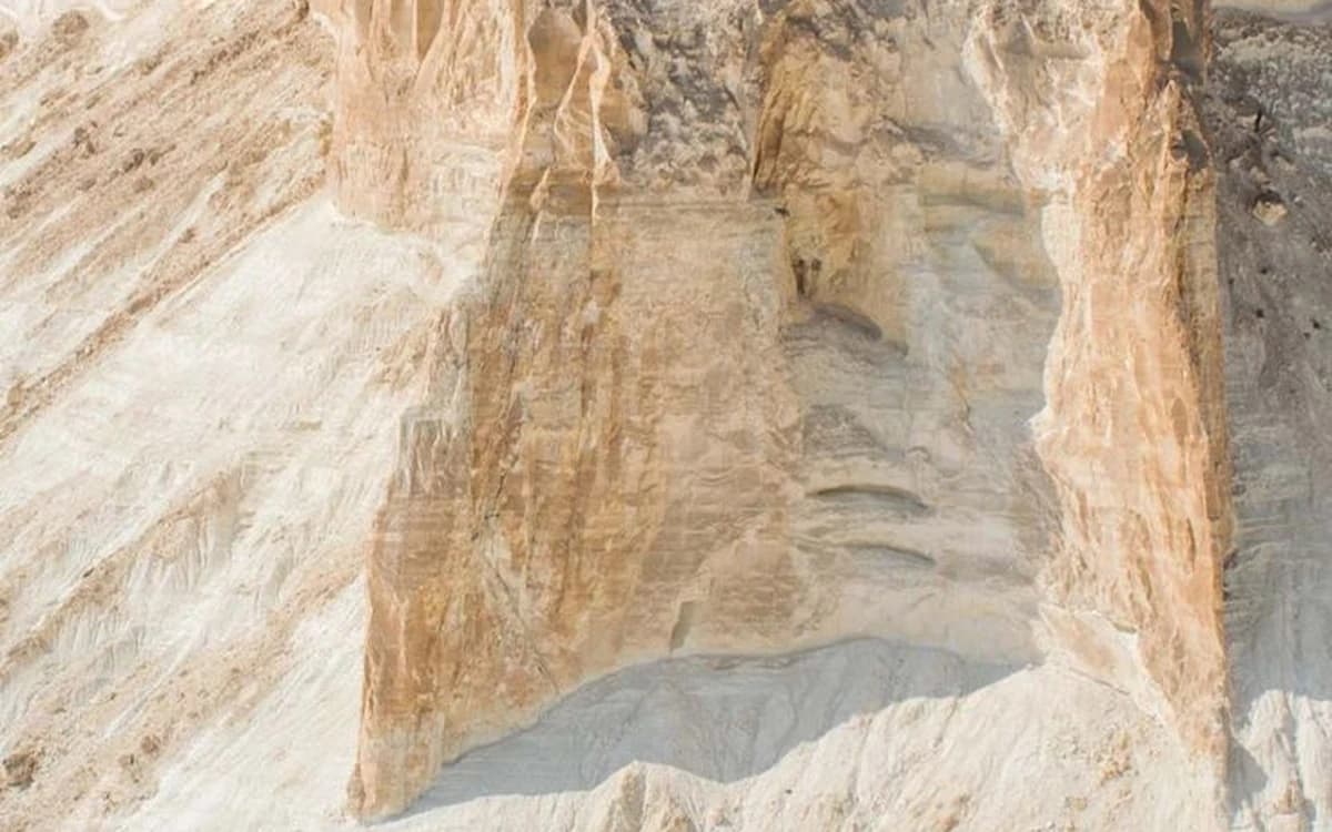 White Desert escarpment in Jordan with pale rock cliffs, carved erosion textures, and arid plateau terrain.