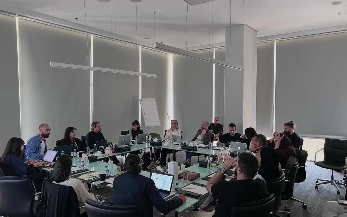 Production meeting in Jordan with crew and production team seated around a conference table during line production planning.