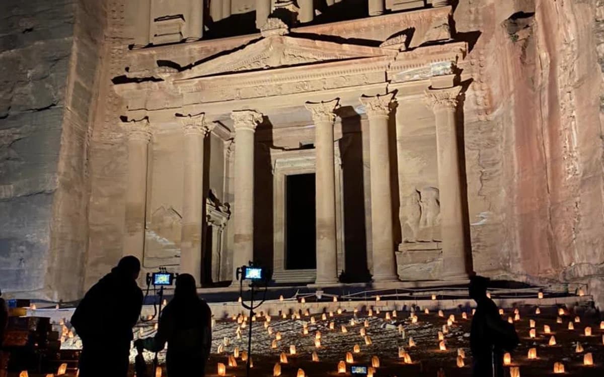 Film crew setting up cameras and lighting at Petra's Treasury at night for a controlled heritage-site shoot in Jordan.