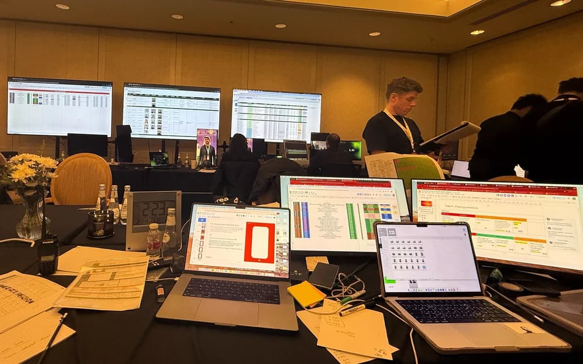 Event production control room in Jordan with laptops, schedules, monitoring screens, and crew coordinating live content operations.