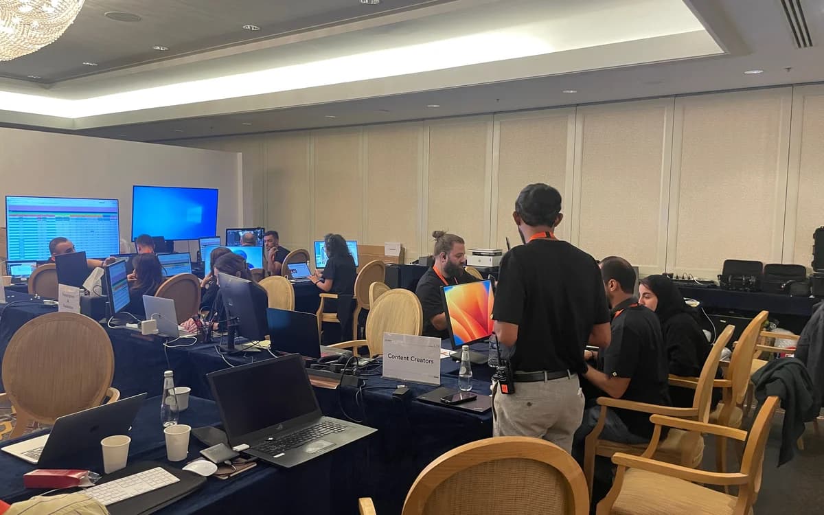 Content production team in Jordan working at laptops and monitors during live event media coverage.