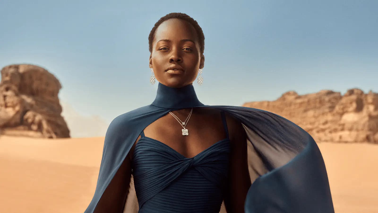 De Beers Where It Begins poster showing a model wearing jewellery in a desert landscape.
