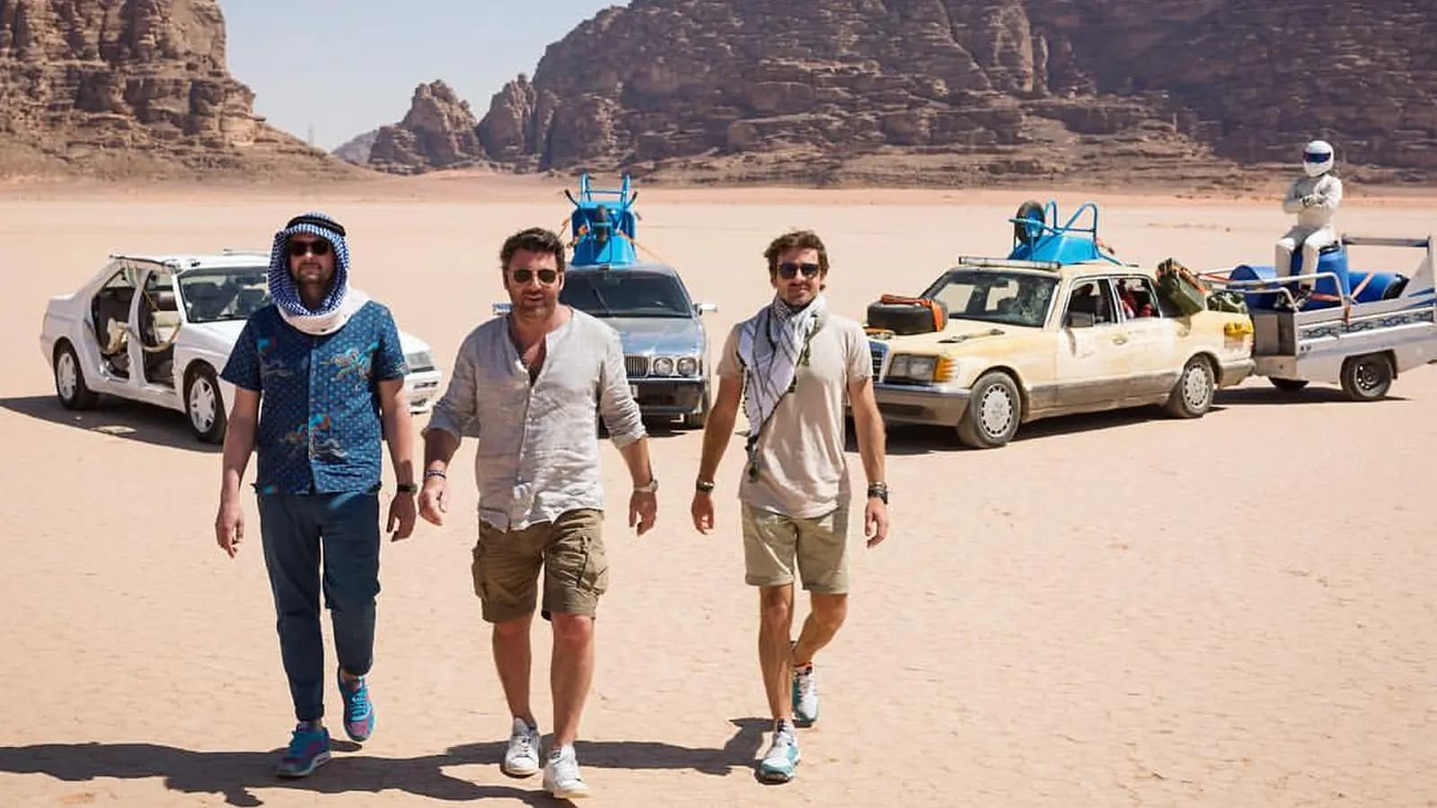 Top Gear France Road Trip en Jordanie poster showing three presenters walking through a desert landscape with cars and sandstone cliffs behind them.