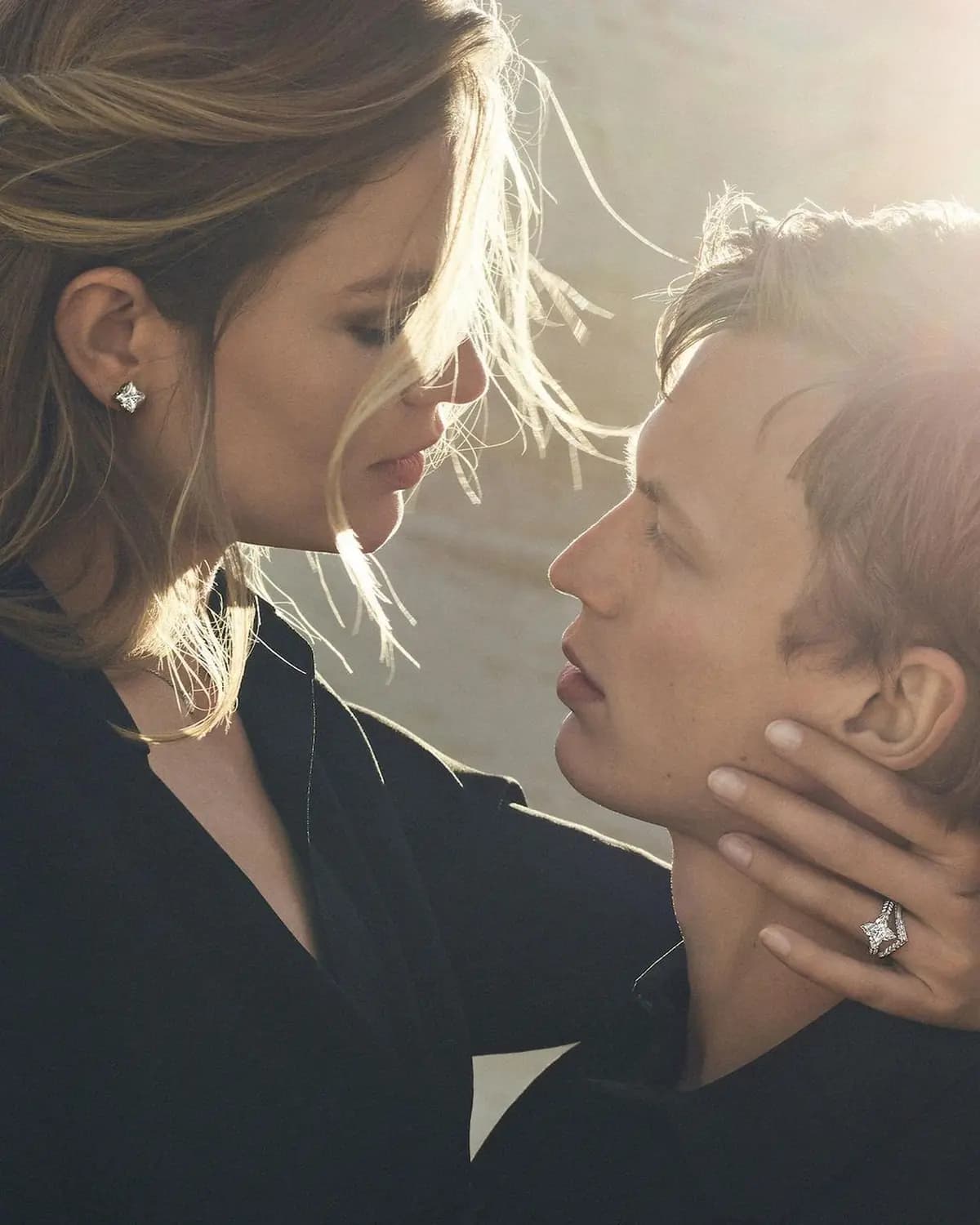 Louis Vuitton Empreinte poster showing a close-up of two models wearing jewellery in soft backlight.