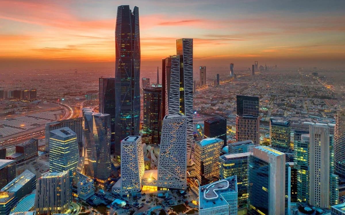 Riyadh skyline in Saudi Arabia at sunset with modern towers, business district buildings, and city lights.