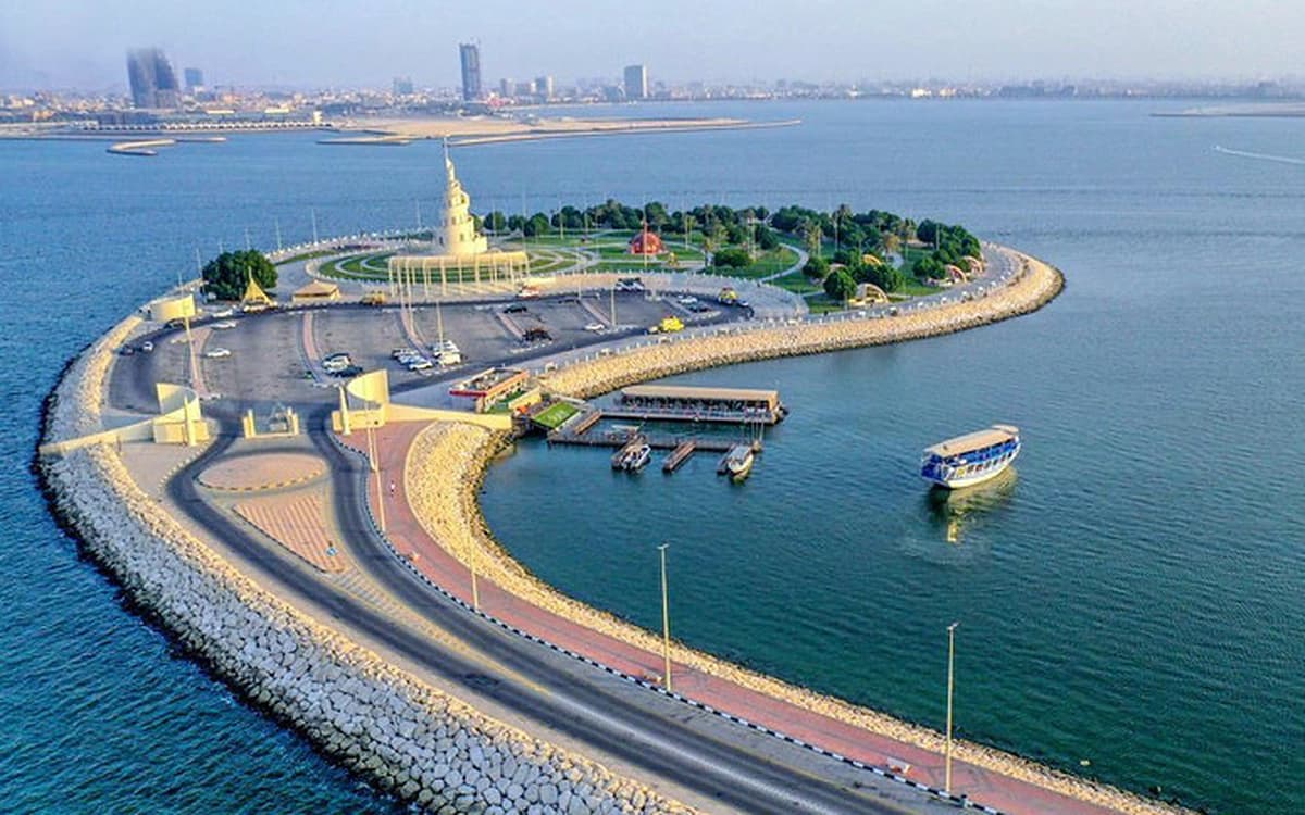 Dammam island waterfront in Saudi Arabia with mosque, boats, promenade roads, and Arabian Gulf water.