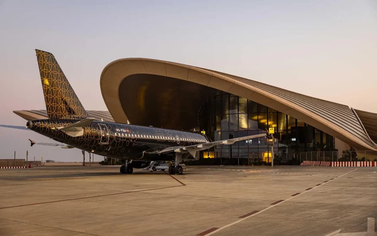Red Sea International Airport terminal in Saudi Arabia with aircraft on the apron and modern desert architecture.