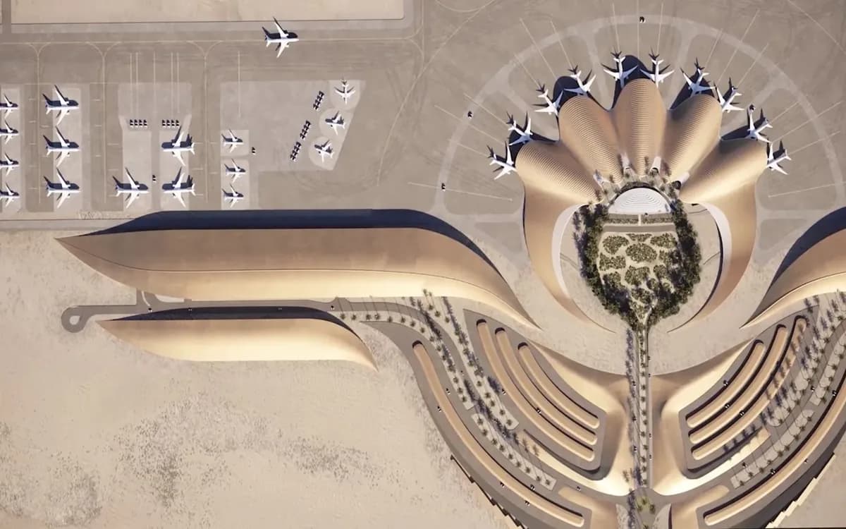 Top-down view of Red Sea International Airport in Saudi Arabia with terminal forms, aircraft stands, and desert surroundings.