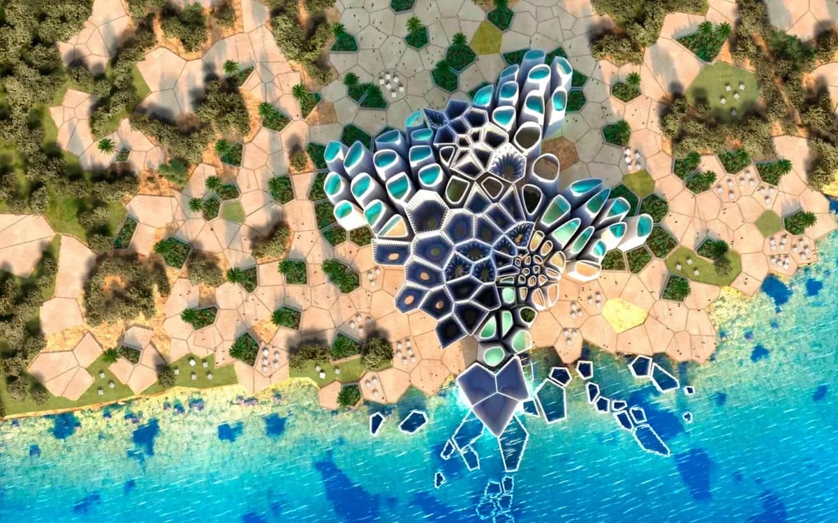 Aerial view of AMAALA Triple Bay coastal architecture beside turquoise Red Sea water and landscaped resort paths.