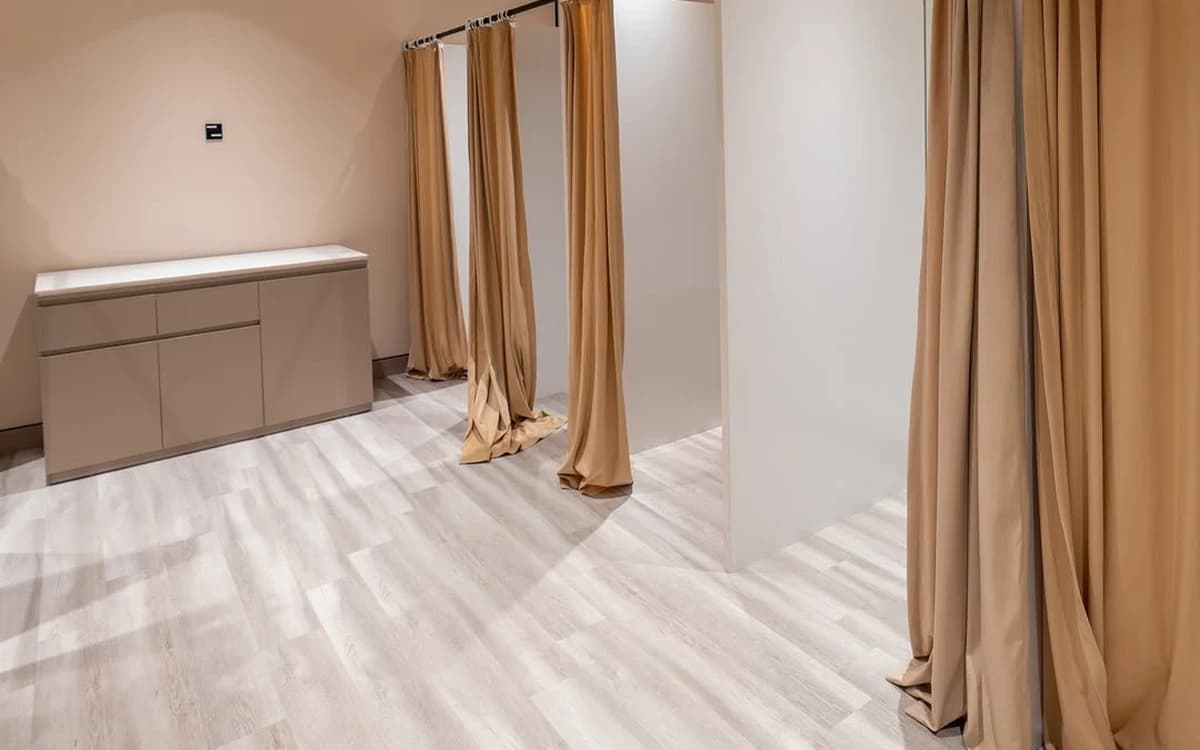 Studio dressing room in Saudi Arabia with curtain fitting booths, partition walls, cabinet, and wardrobe preparation space.