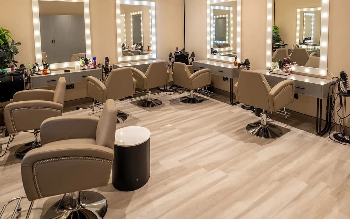 Hair and makeup room in Saudi Arabia with lit mirrors, styling chairs, workstations, and production support space.
