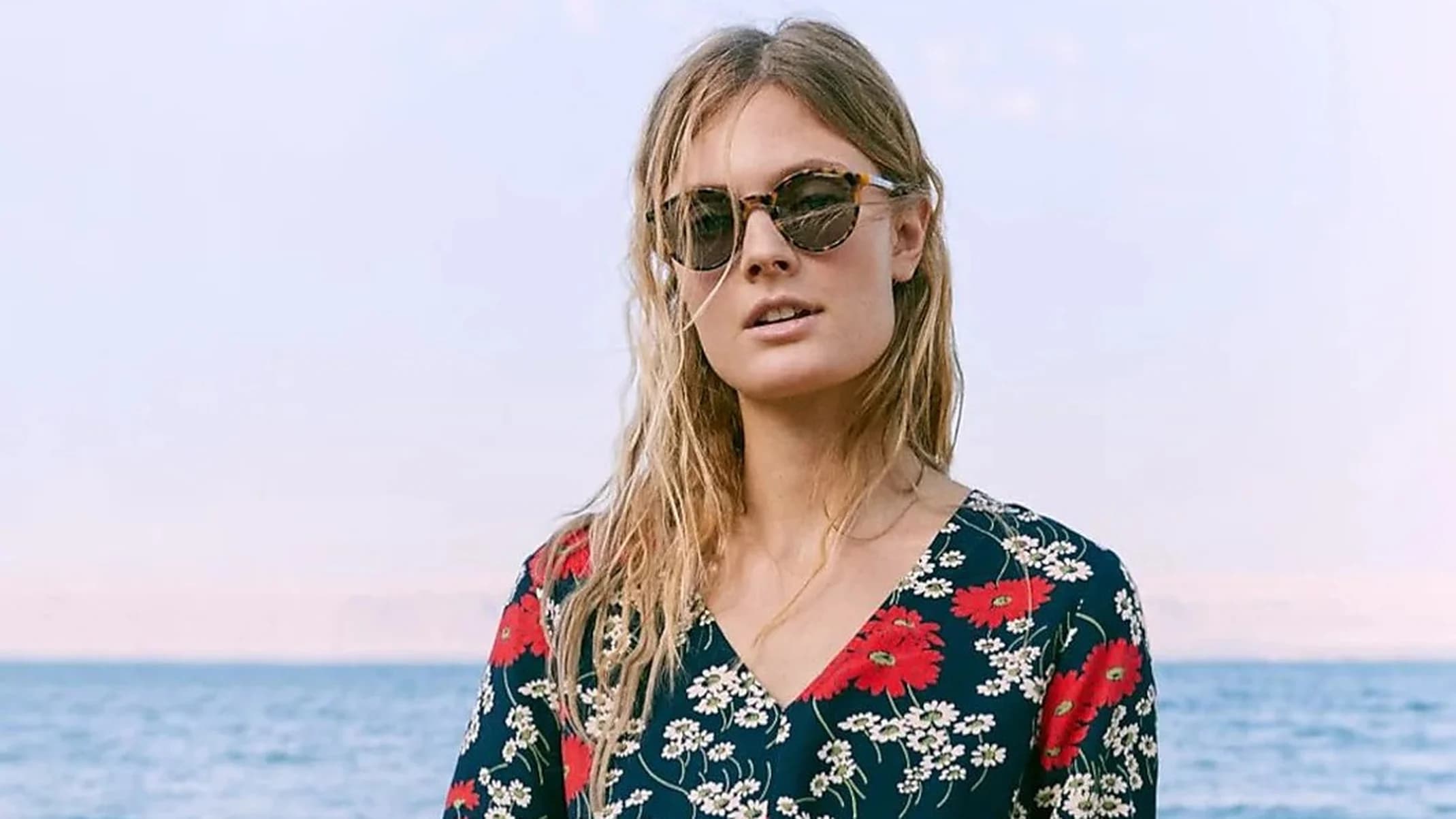 Madewell Spring Collection fashion portrait of a woman in a floral top and denim skirt by the Dead Sea in Jordan.