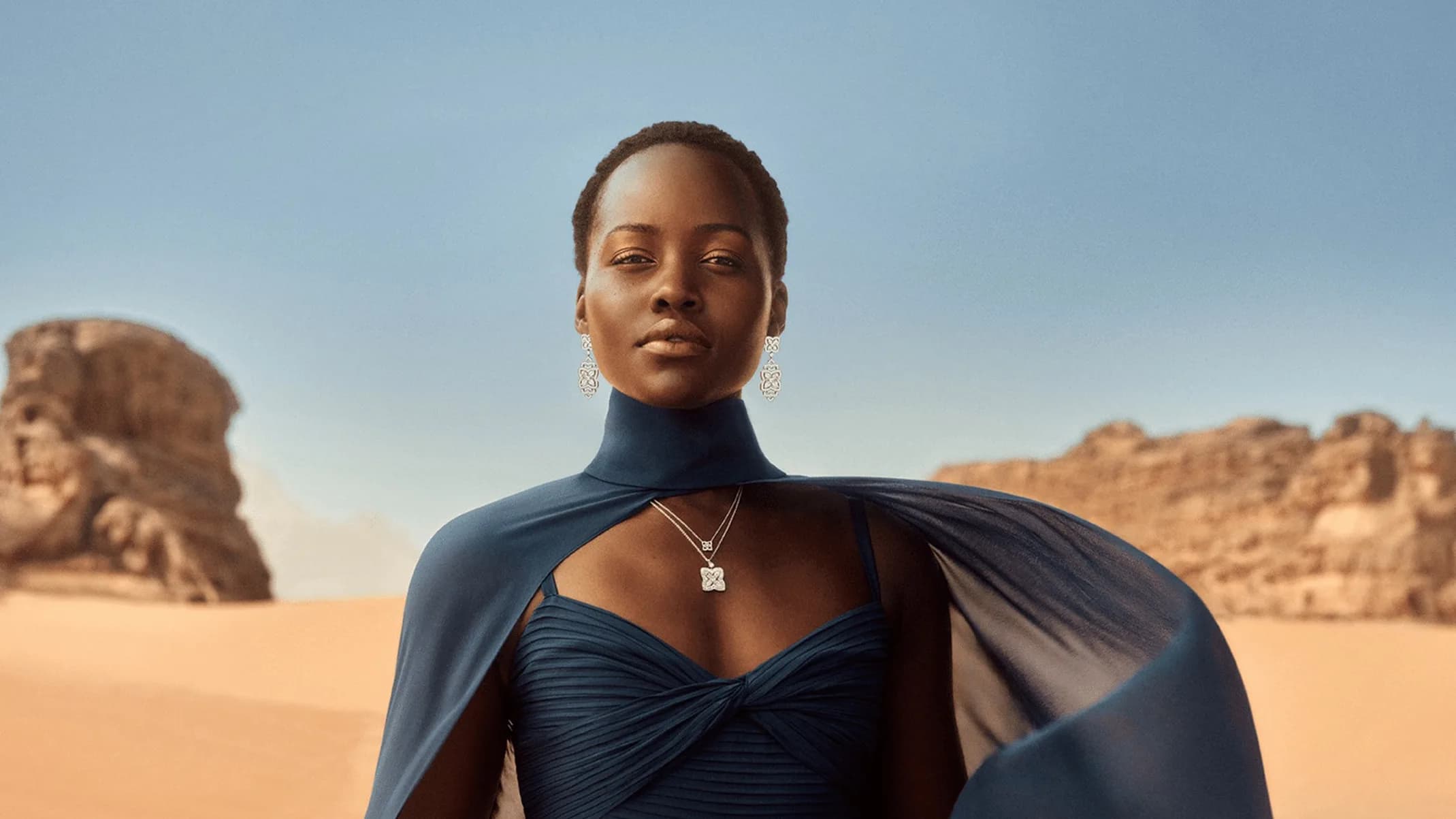 De Beers Where It Begins jewellery campaign portrait of a model in a blue dress in Wadi Rum, Jordan.