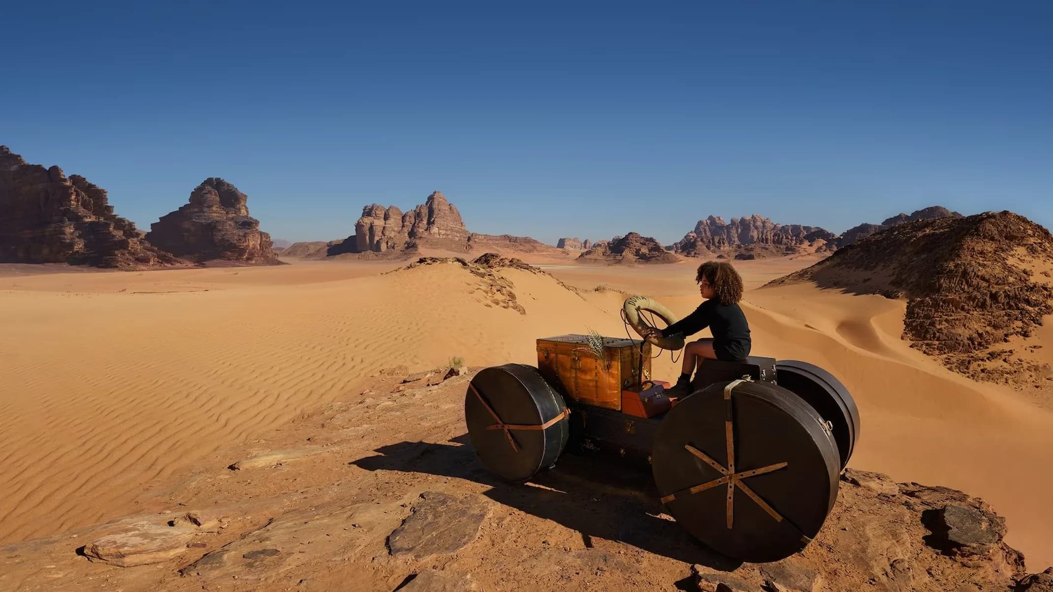 Louis Vuitton Towards a Dream campaign image of children playing among sandstone columns in Wadi Rum, Jordan.